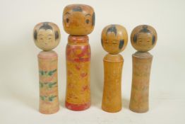 Four Japanese turned and painted wood Kokeshi dolls, largest 12" high