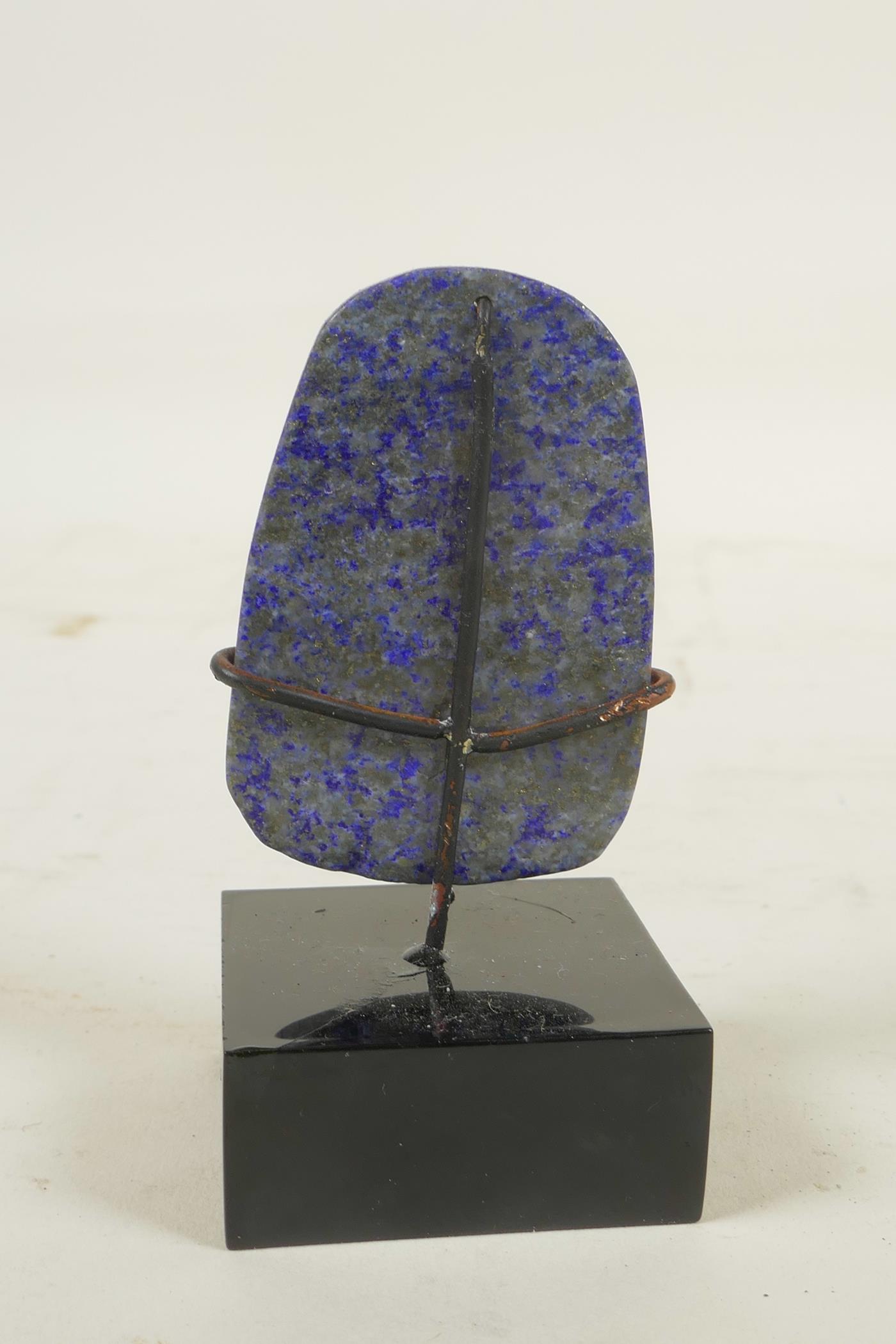 A Chinese carved lapis lazuli pendant decorated with Buddha, in a display mount - Image 2 of 2
