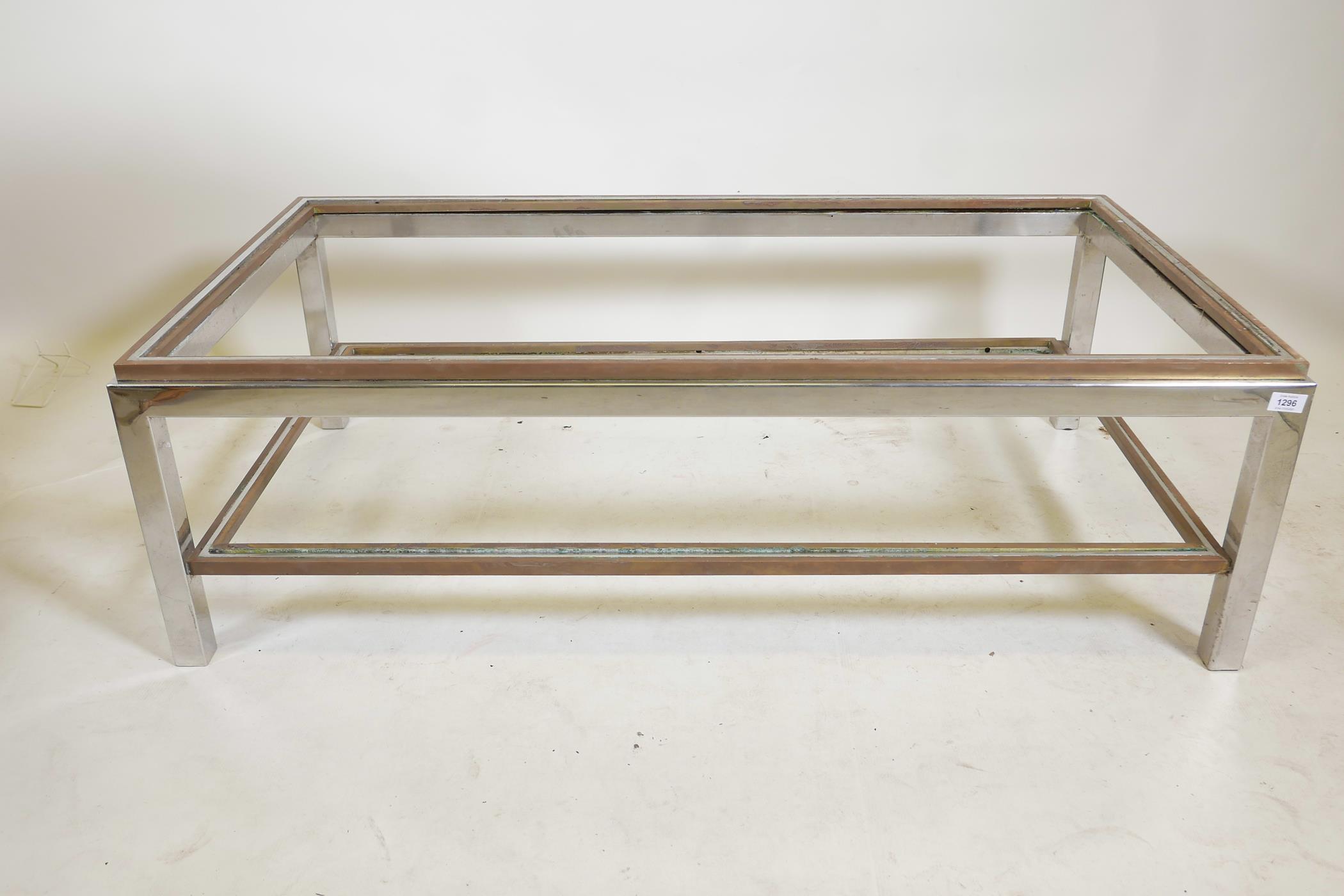A chrome and brass two tier coffee table in the style of Zevi, 51" x 27½" x 16", A/F lacks glass