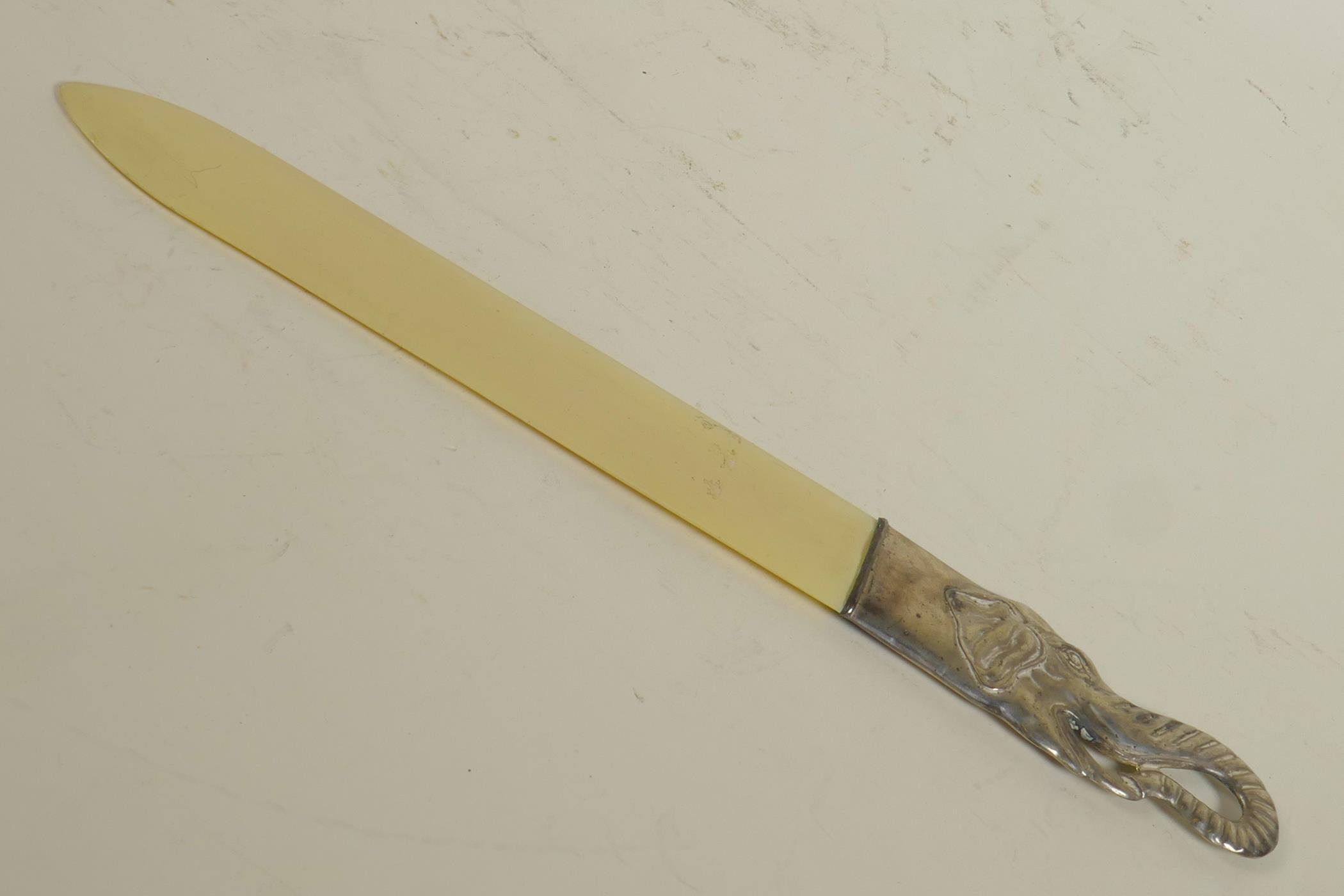 A bone letter opener with silver plated elephant's head handle, 10½" long