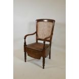 A beech framed commode armchair with bergere panel back by Carter's Ltd, 39" high