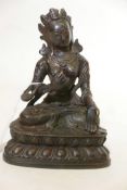 A Bronze Buddhistic figure, seated upon a lotus throne, with distressed gilt decoration, 7" high