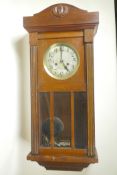 A 1930s German mahogany wall clock with a violin movement striking on a gong, 13" wide, 31" high