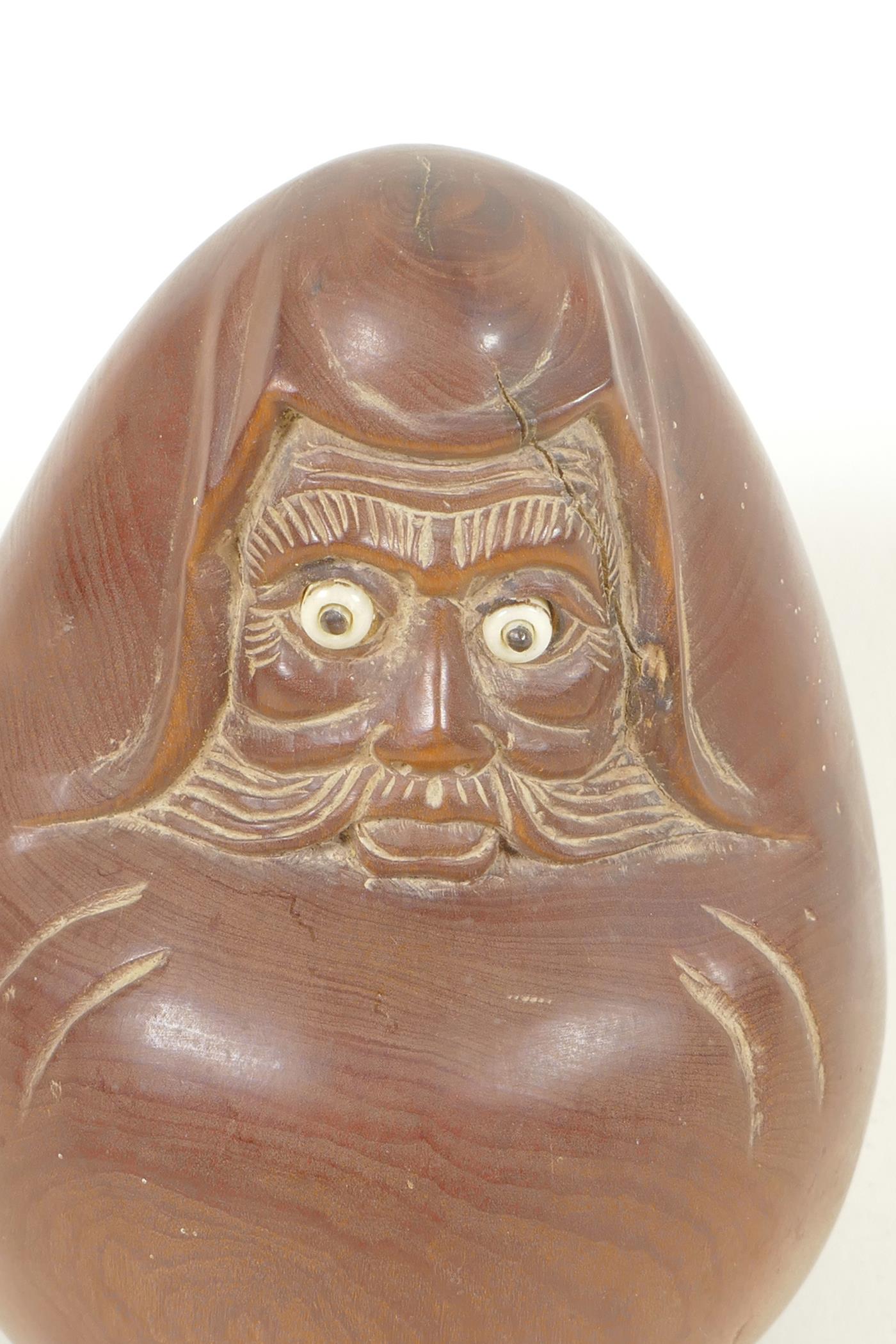 A Japanese carved hardwood okimono figure of a rounded man with bone and glass eyes, character - Image 2 of 4