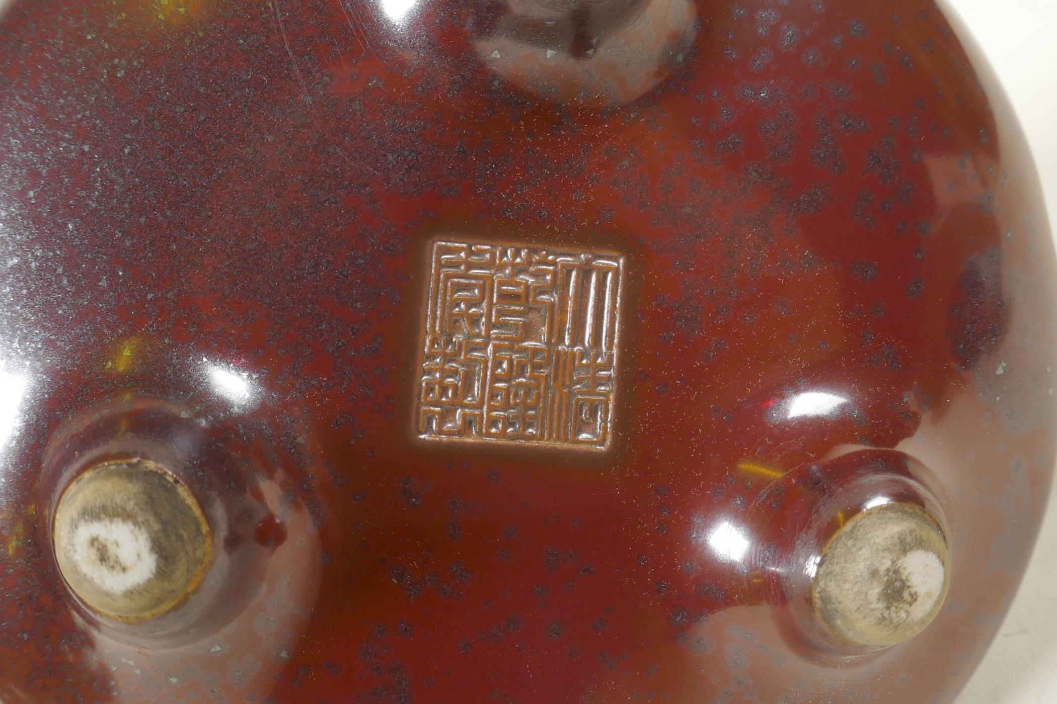 A Chinese copper glazed porcelain censer with two handles, raised on tripod supports, impressed seal - Image 5 of 6