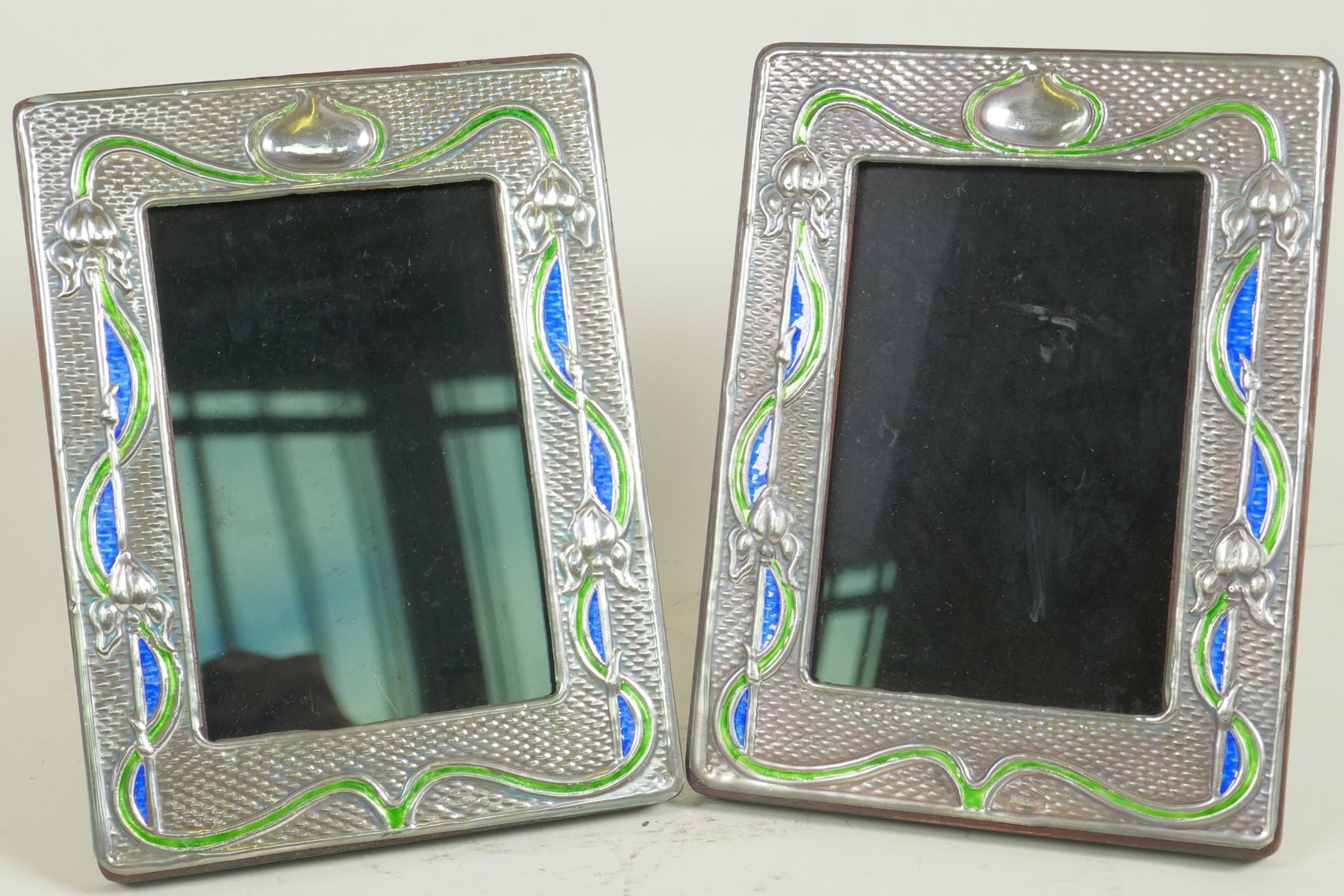 A pair of Art Nouveau style sterling silver photo frames with blue and green enamelled decoration,