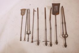 A quantity of Victorian brass and steel fire irons, largest tongs 29"