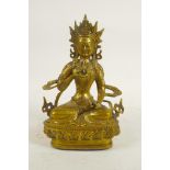 A Sino-Tibetan gilt metal Buddha seated on a lotus throne, double vajra mark to base, 8" high