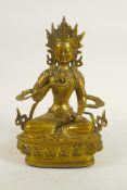 A Sino-Tibetan gilt metal Buddha seated on a lotus throne, double vajra mark to base, 8" high