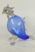 A blue glass decanter with silver plated head, legs and feet in the form of a parrot, 6½" high