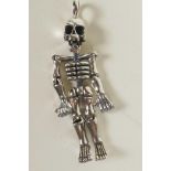 A silver articulated pendant in the form of a human skeleton, 2" long