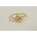 A yellow gold diamond two stone crossover ring, untested, approximate size 'J/K'