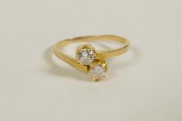 A yellow gold diamond two stone crossover ring, untested, approximate size 'J/K'