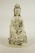 A Chinese blanc de chine porcelain figure of Quan Yin seated on a lotus throne, impressed marks