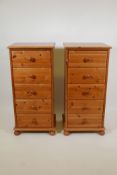 A pair of pine tallboys with five drawers raised on ball feet, 18" x 15" x 38"high