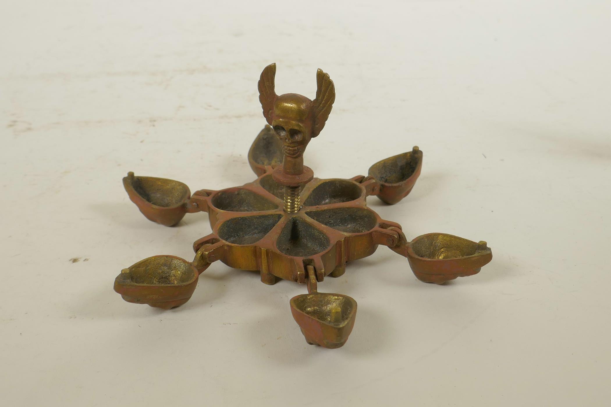 An Indian brass tika box with skull decoration, together with a bronzed metal figure of a many armed - Image 3 of 3