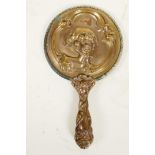 A C19th Art Nouveau bronze hand mirror embossed with scrolls and faces, and bejewelled glass mirror,