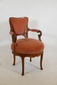 A C19th Art Nouveau, walnut, tub shaped swivel armchair, with carved and pierced, shaped back,