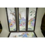 A set of four Chinese porcelain wall plaques decorated with figures and animals in bright enamels,