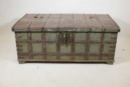 An Indian teak chest with iron strapwork and hinged fold over top, and traces of original paint, 49"