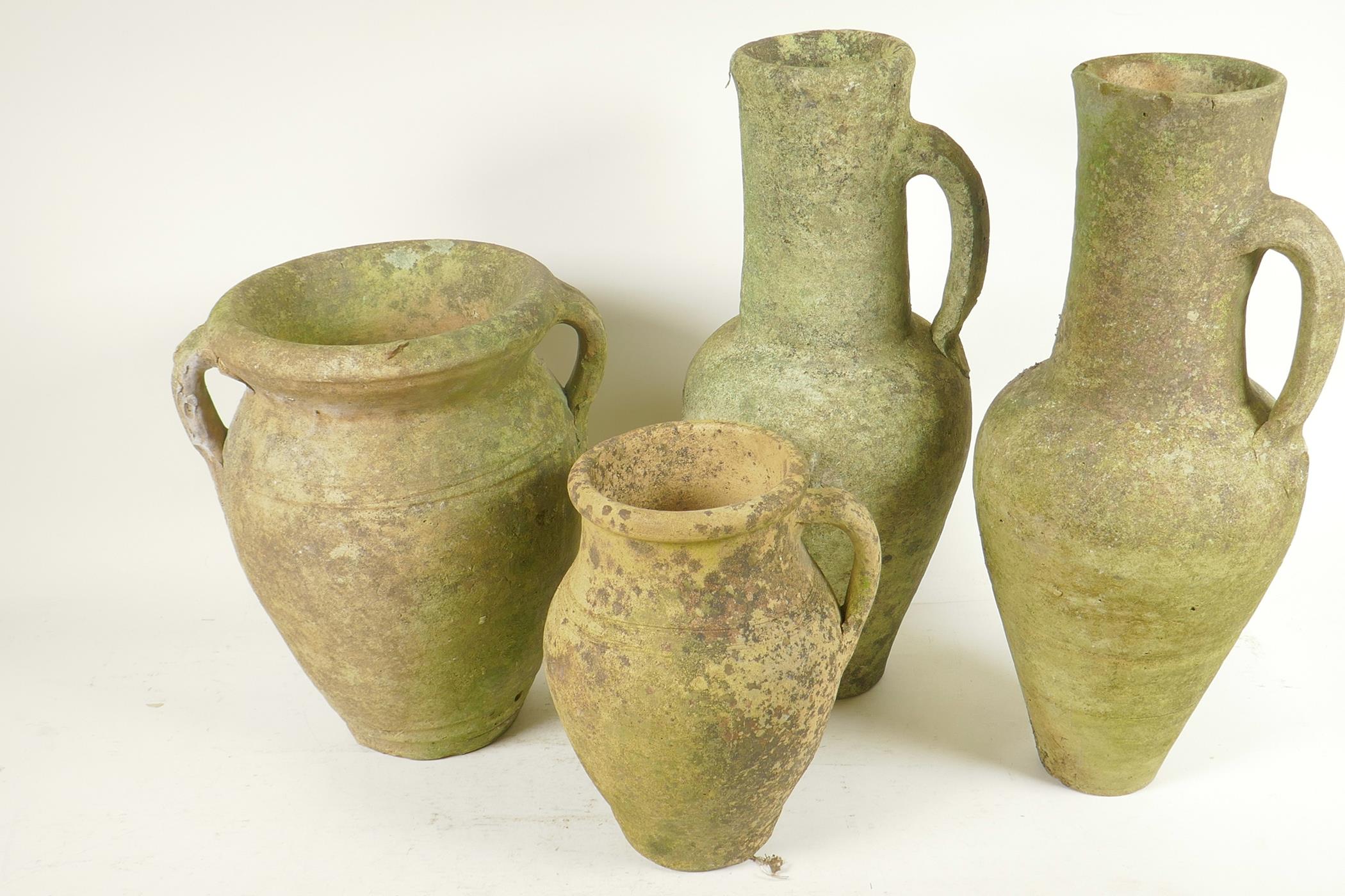 Four terracotta garden ornaments, a pair of Grecian style jugs, 15" high, a two handled vase and a