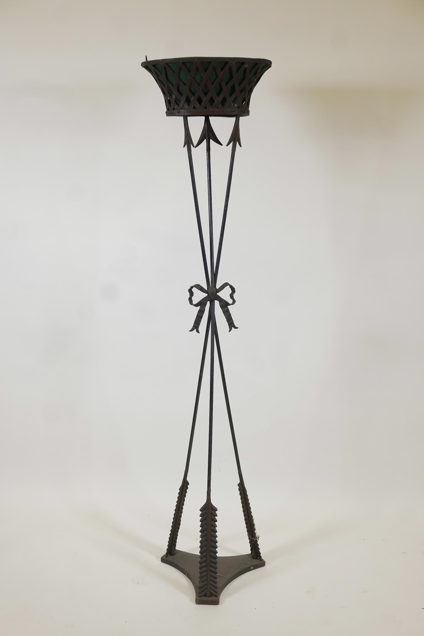 A wrought metal torchere with painted toleware liner, 58" high