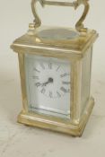 A silver plated carriage clock with white enamelled dial and Roman numerals, comes with key, 3¼"