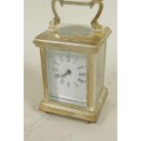A silver plated carriage clock with white enamelled dial and Roman numerals, comes with key, 3¼"