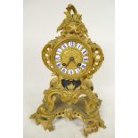 An ormolu Rococo style mantel clock, the movement striking on a gong, with gilded dial and inset