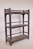 An Indian teak three tier open rack, with distressed paint traces, 36" x 13", 48" high