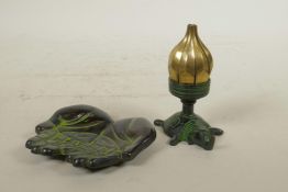 An Indian bronze oil lamp in the form of a lotus flower on an elephant shaped base, opening to