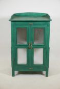 An Indian painted hardwood display cabinet with two glazed doors, three quarter gallery and panelled