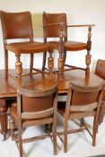 A Victorian mahogany wind out dining table on turned and carved legs, with a single leaf, and six