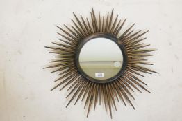 A painted metal sunburst wall mirror, 23" diameter