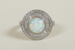 A 925 silver dress ring set with an opalite encircled by cubic zirconium, approximate size 'Q'