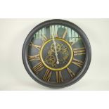 A decorative wall clock with quartz movement and open gear decoration with cut out Roman numerals,