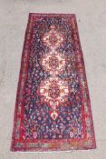 A Persian thick pile blue ground runner with a multicoloured floral design, 50½" x 125"