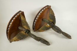 A pair of mahogany corner wall brackets with bobbin turned galleries supported on carved and painted