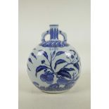 A Chinese Ming style blue and white porcelain moon flask with two handles, decorated with fruit
