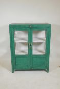 An Indian painted hardwood two door display cabinet, lacks one glass pane to side, 30" x 15" x 39"