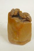 A naturalistic Chinese carved soapstone seal, the top carved as two birds, 3" long