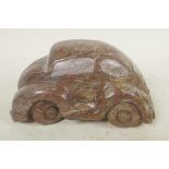 A carved cobalt stone artwork in the form of a Volkswagen Beetle, 7½" long