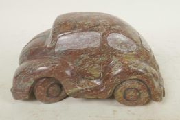 A carved cobalt stone artwork in the form of a Volkswagen Beetle, 7½" long