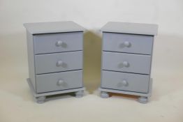 A pair of painted pine three drawer bedside chests, 17" x 15" x 23" high