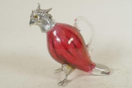 A small cranberry glass decanter in the form of a parrot with silver plated head and feet, 6½" high