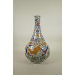 A Chinese Wucai porcelain bottle vase decorated with carp in a lotus pond, 6 character mark to neck,