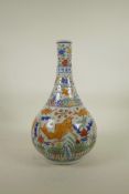 A Chinese Wucai porcelain bottle vase decorated with carp in a lotus pond, 6 character mark to neck,