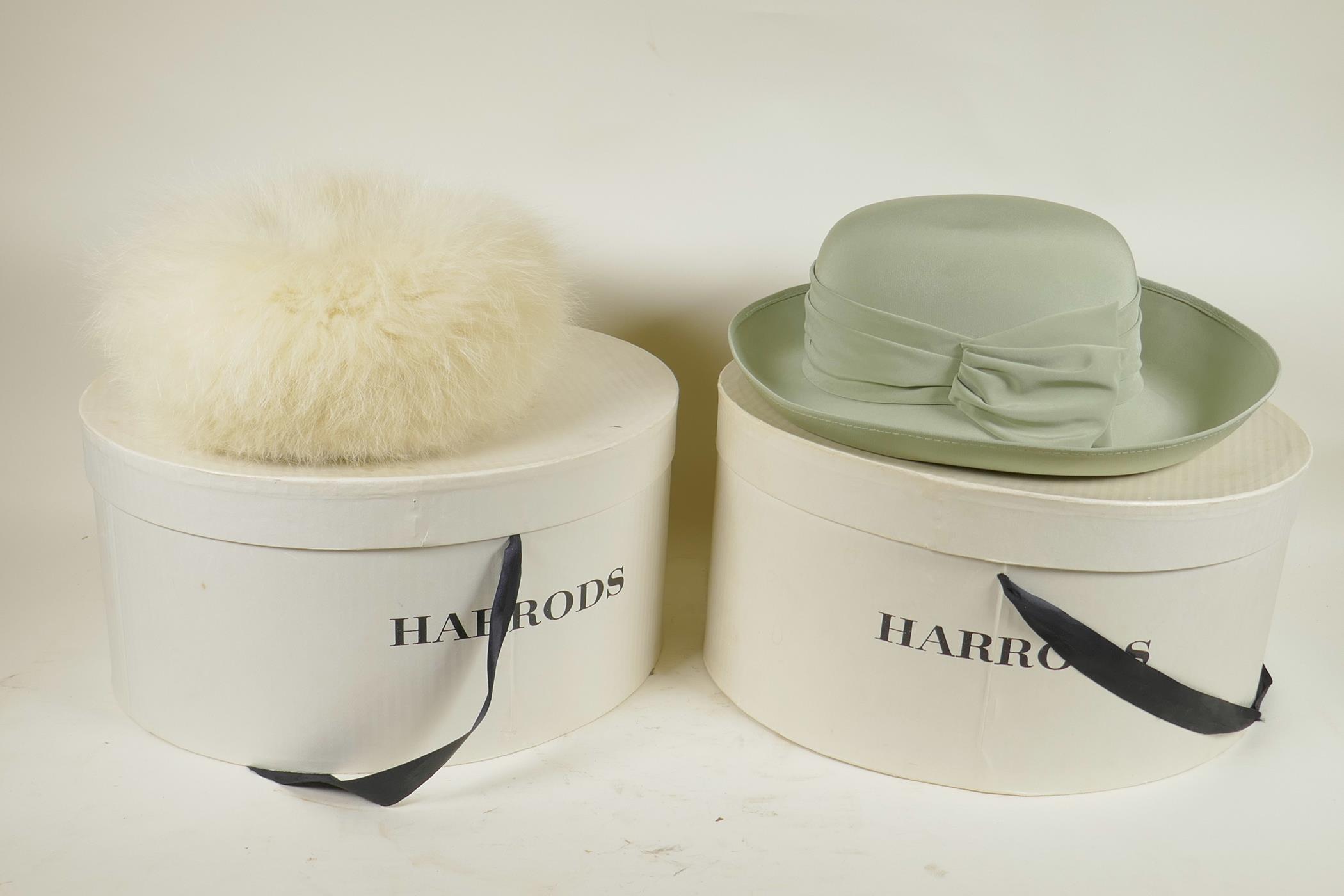 A ladies' Jacques Vert hat and a Russian white fox fur hat, both in Harrods hat boxes