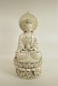 A Chinese blanc de chine figure of Quan Yin seated on a lotus throne, seal marks verso, 20" high