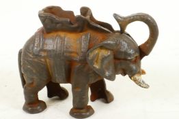 A cast iron trick moneybox cast as an elephant with howdah, 5" high